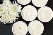 Body Butter 6 jars without lid and a top down view.