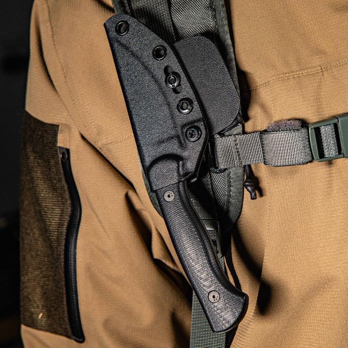 Montana Knife Company - The Blackfoot Fixed Blade 2.0 - Black - Knife inside black Kydex sheath attached to a backpack strap being worn by a person